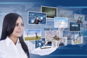 Businesswoman is using digital touchscreen to choose photos/pictures